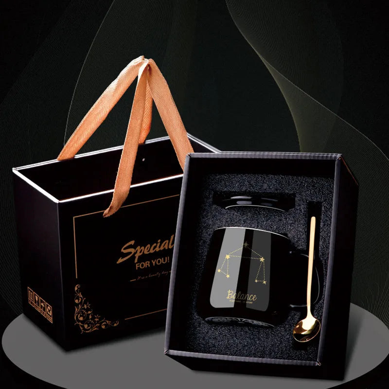 Black mug with gold spoon and 'Special For You' gift bag on a dark background