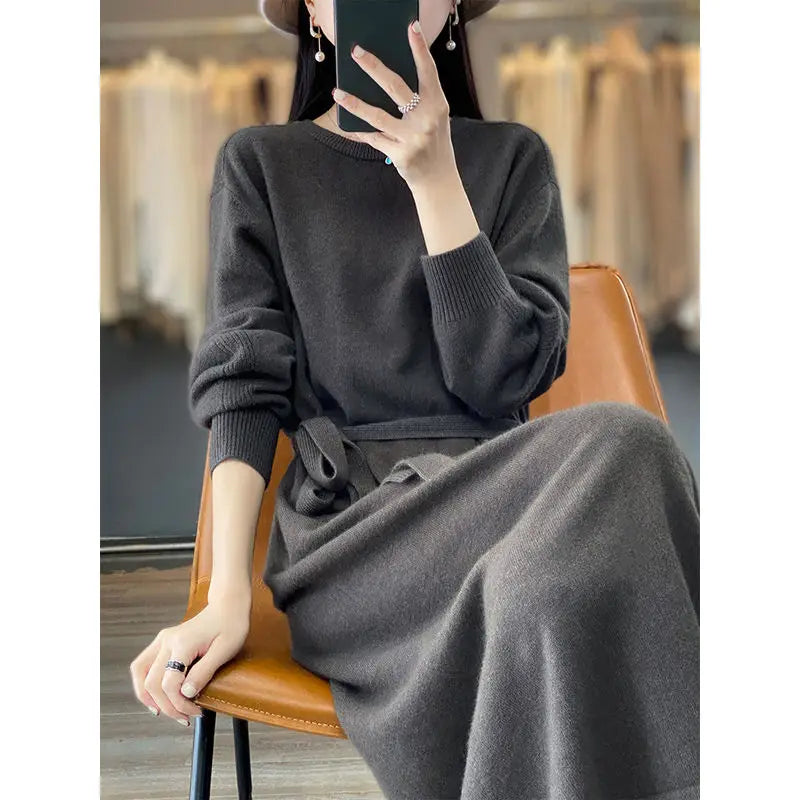 Person wearing a gray outfit sitting on a chair in a store setting.