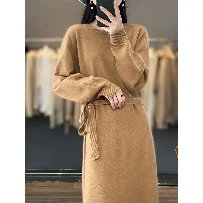 Person wearing a brown sweater dress in a clothing store.