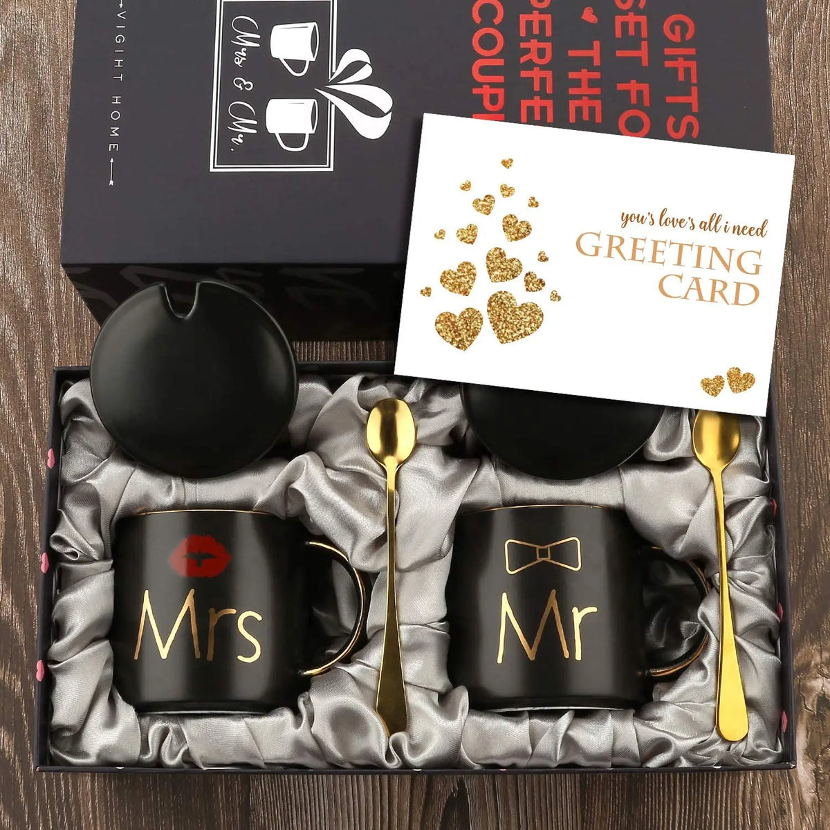 Gift set with 'Mr' and 'Mrs' mugs, spoons, and a card in a box.