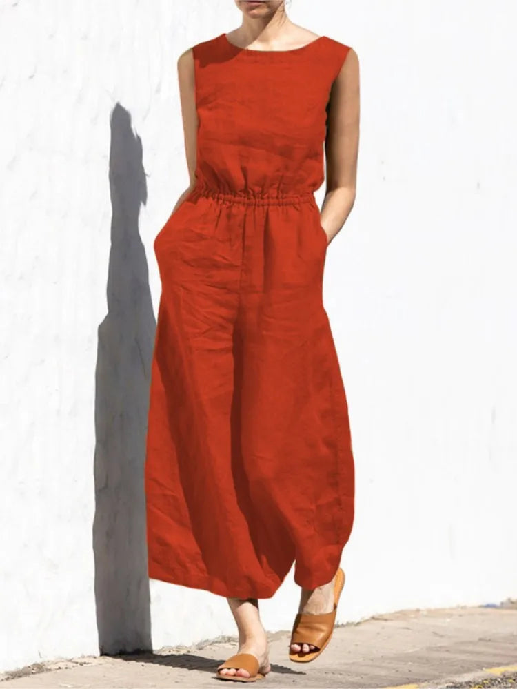 Person wearing a red jumpsuit against a white wall.