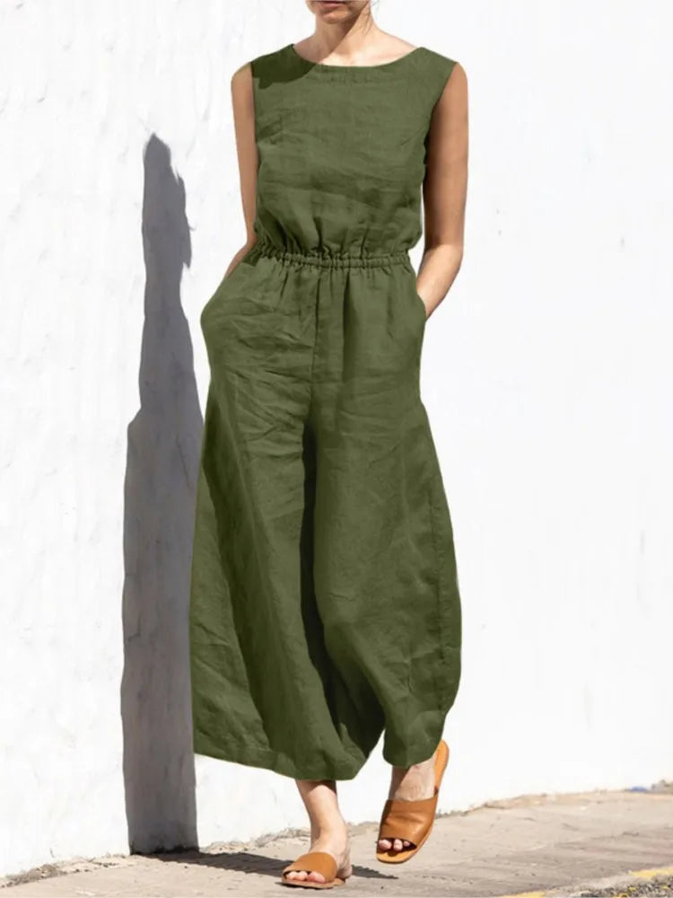Person wearing a green jumpsuit against a white wall.