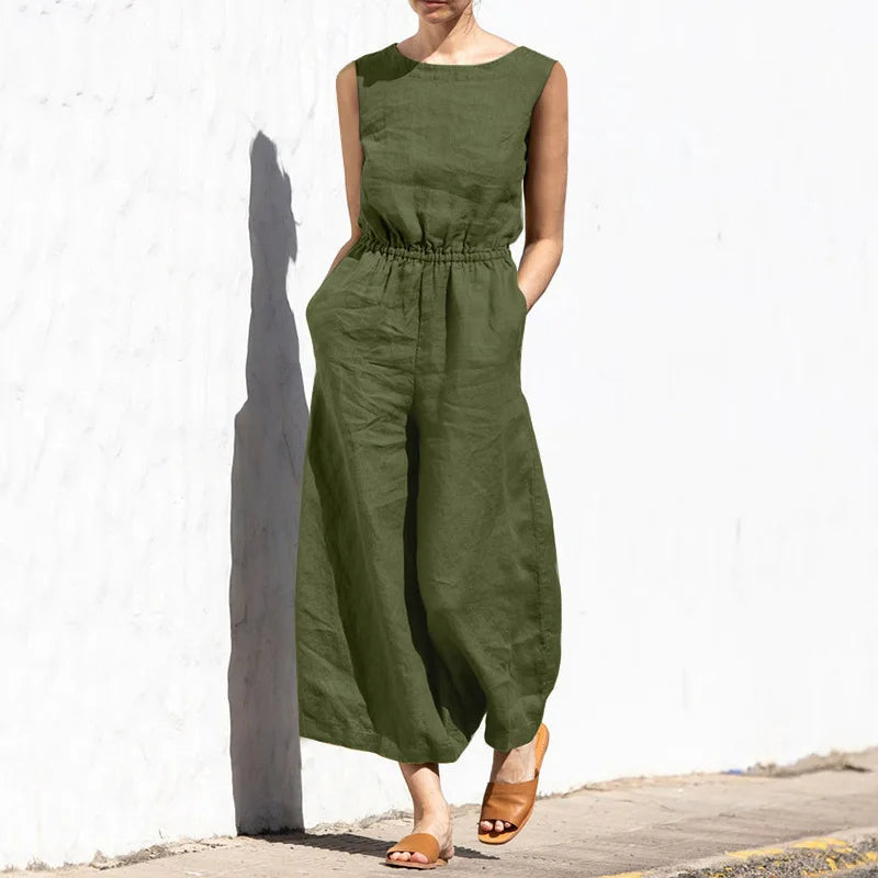 Person wearing a green jumpsuit against a white wall
