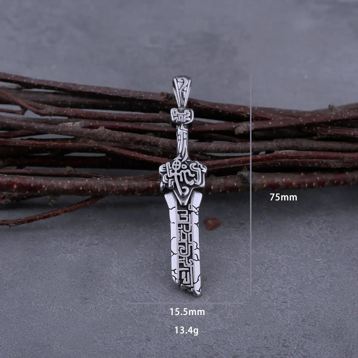 Silver pendant on a branch with measurements displayed