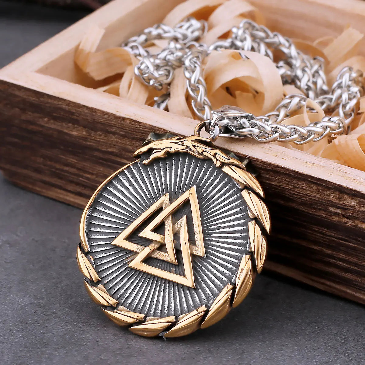 Gold and silver pendant necklace on a wooden box