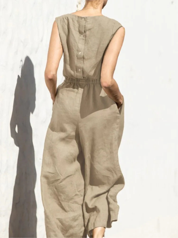 Person wearing a beige jumpsuit against a white background